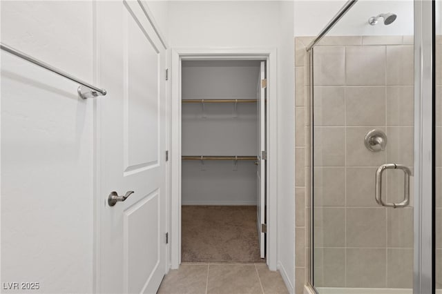 1398 Pin Cushion Rdg, Mesquite, NV 89034 - bathroom with a stall shower, tile patterned floors, and a spacious closet