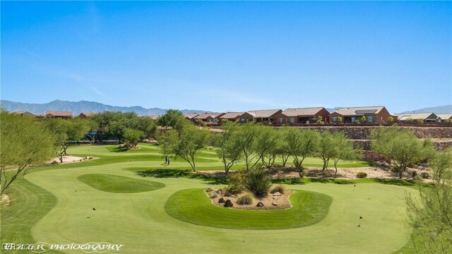 1398 Pin Cushion Rdg, Mesquite, NV 89034 - surrounding community with an area to practice putting, view of golf course, and a mountain view