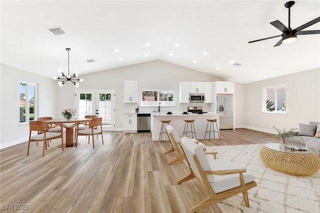 811 Spyglass Ln, Las Vegas, NV 89107 - living room with light wood-type flooring, high vaulted ceiling, a chandelier, recessed lighting, and baseboards