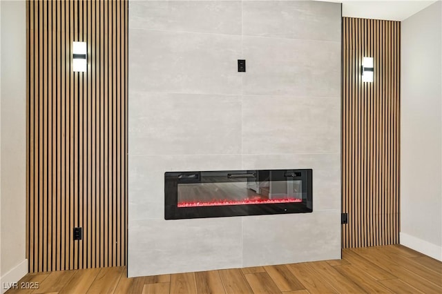 6388 Canyon Dawn Ave, Las Vegas, NV 89108 - detailed view of a glass covered fireplace, wood finished floors, and baseboards