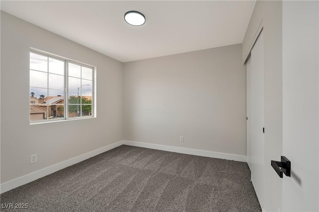 6388 Canyon Dawn Ave, Las Vegas, NV 89108 - empty room with dark carpet and baseboards