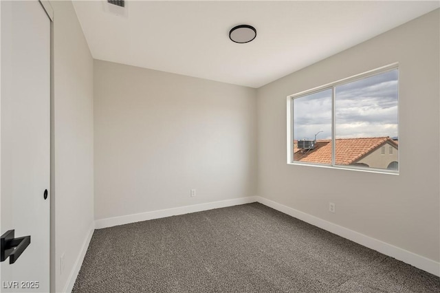 6388 Canyon Dawn Ave, Las Vegas, NV 89108 - spare room featuring dark carpet and baseboards