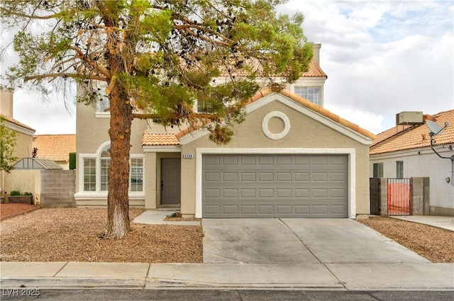 6388 Canyon Dawn Ave, Las Vegas, NV 89108 - mediterranean / spanish-style house with a tile roof, stucco siding, concrete driveway, a garage, and a gate