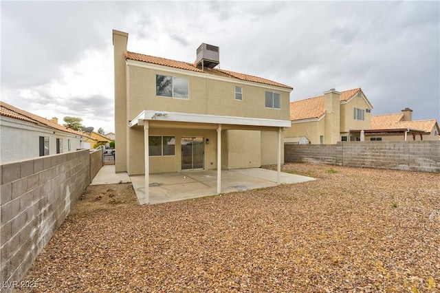 6388 Canyon Dawn Ave, Las Vegas, NV 89108 - rear view of property featuring stucco siding, a fenced backyard, a tiled roof, a chimney, and a patio