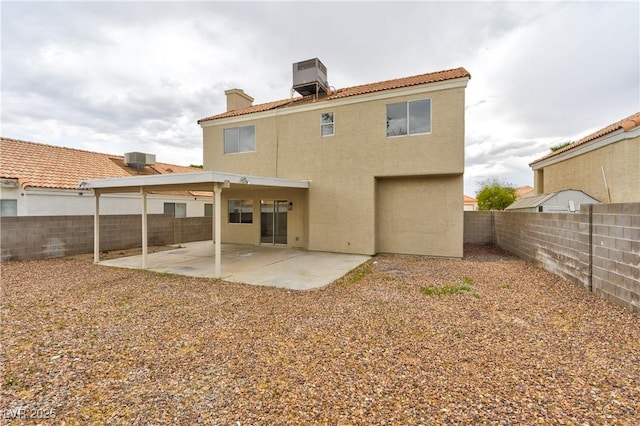 6388 Canyon Dawn Ave, Las Vegas, NV 89108 - rear view of house with stucco siding, a fenced backyard, a patio, and a chimney