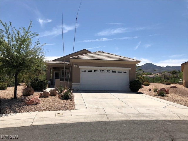 1396 Couperin Dr, Henderson, NV 89052 - ranch-style home with a garage, concrete driveway, stucco siding, and a mountain view