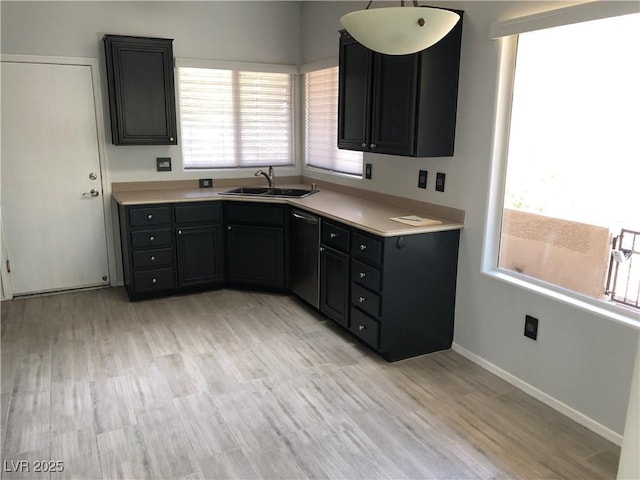 1396 Couperin Dr, Henderson, NV 89052 - kitchen featuring dishwasher, a sink, light countertops, and light wood-style floors