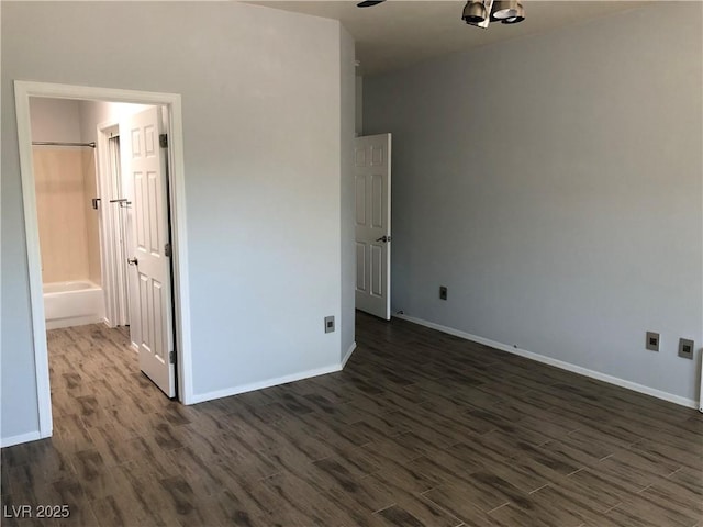 1396 Couperin Dr, Henderson, NV 89052 - unfurnished bedroom featuring dark wood-style floors, baseboards, and connected bathroom