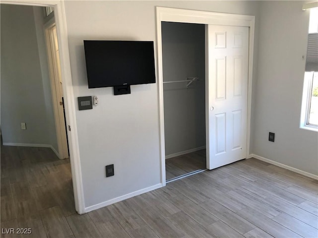 1396 Couperin Dr, Henderson, NV 89052 - unfurnished bedroom featuring wood finished floors, baseboards, and a closet
