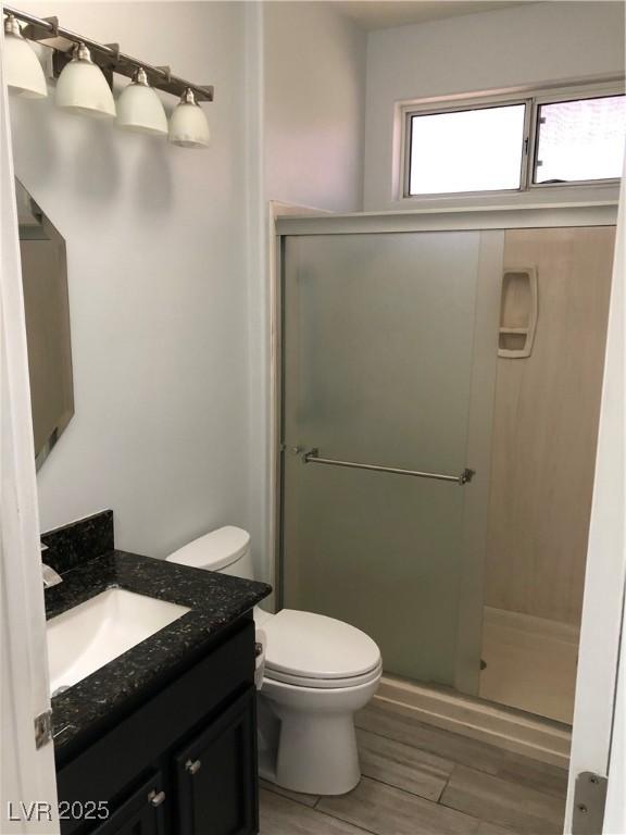 1396 Couperin Dr, Henderson, NV 89052 - full bathroom featuring vanity, a shower stall, toilet, and wood finished floors