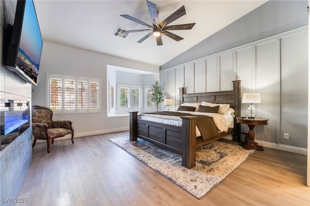 2144 Paganini Ave, Henderson, NV 89052 - bedroom with a glass covered fireplace, wood finished floors, high vaulted ceiling, baseboards, and a ceiling fan