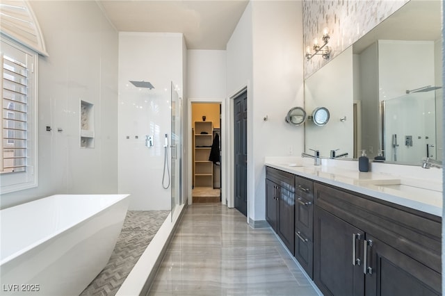 2144 Paganini Ave, Henderson, NV 89052 - full bath with a shower stall, double vanity, a freestanding tub, a walk in closet, and a towering ceiling