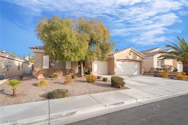 2144 Paganini Ave, Henderson, NV 89052 - view of front of house featuring a tile roof, stucco siding, a garage, and driveway