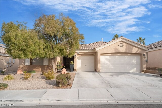 2144 Paganini Ave, Henderson, NV 89052 - view of front of property featuring stucco siding, a garage, concrete driveway, and a tile roof