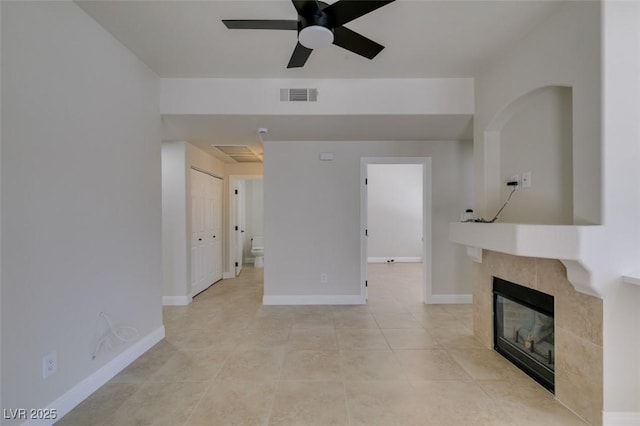 9050 W Warm Springs Rd Unit 1117, Las Vegas, NV 89148 - unfurnished living room featuring a ceiling fan, light tile patterned floors, a tile fireplace, and baseboards
