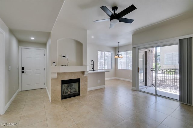 9050 W Warm Springs Rd Unit 1117, Las Vegas, NV 89148 - unfurnished living room with baseboards, a sink, light tile patterned floors, a chandelier, and recessed lighting