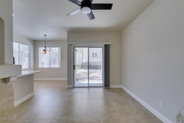 9050 W Warm Springs Rd Unit 1117, Las Vegas, NV 89148 - empty room featuring a ceiling fan, a chandelier, light tile patterned floors, and baseboards