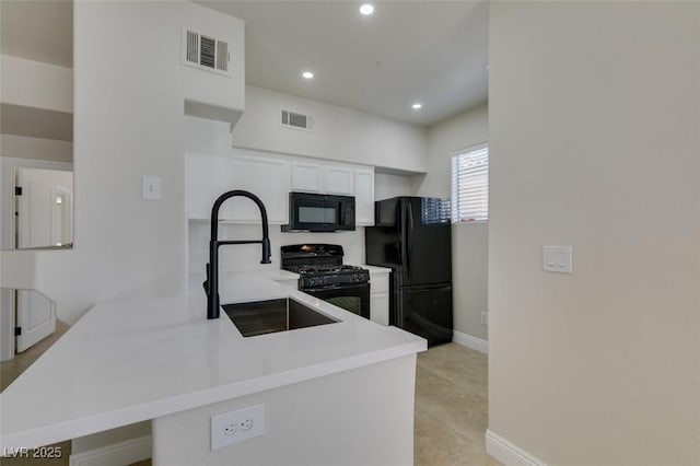 9050 W Warm Springs Rd Unit 1117, Las Vegas, NV 89148 - kitchen featuring black appliances, a peninsula, a sink, white cabinetry, and recessed lighting