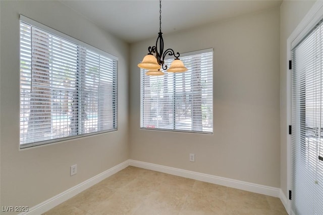 9050 W Warm Springs Rd Unit 1117, Las Vegas, NV 89148 - unfurnished dining area featuring a chandelier, healthy amount of natural light, and baseboards