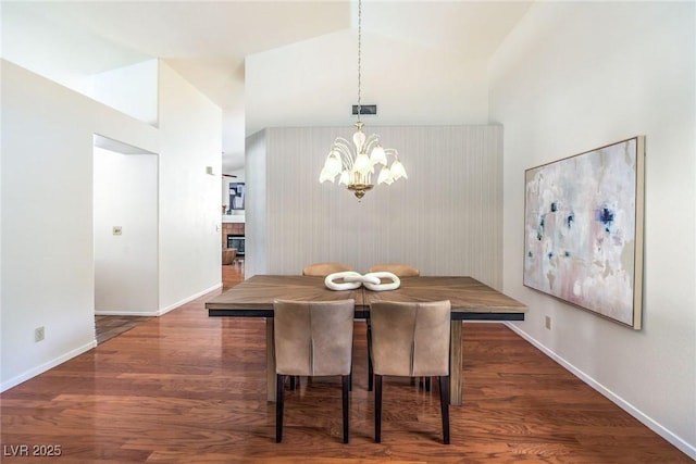 8428 Apple Hill Ct, Las Vegas, NV 89128 - dining room with a chandelier, baseboards, wood finished floors, and lofted ceiling