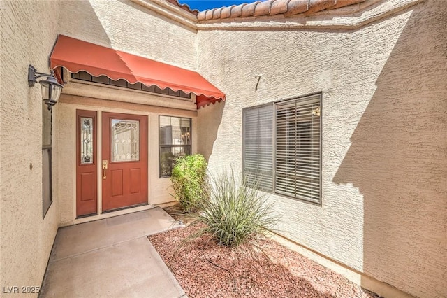 8428 Apple Hill Ct, Las Vegas, NV 89128 - doorway to property featuring stucco siding and a tile roof