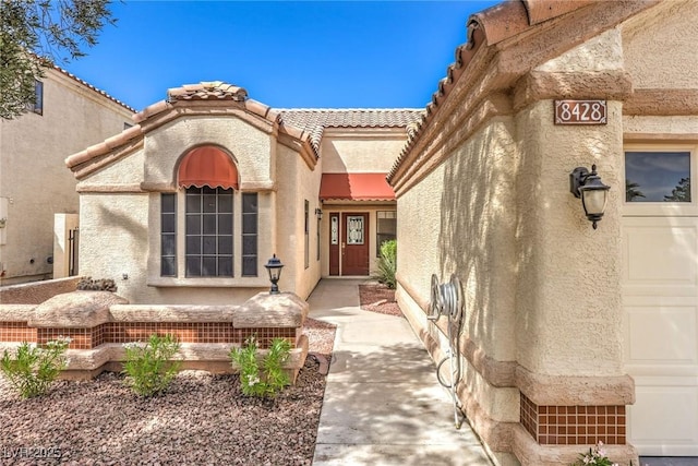 8428 Apple Hill Ct, Las Vegas, NV 89128 - doorway to property featuring stucco siding and a tiled roof