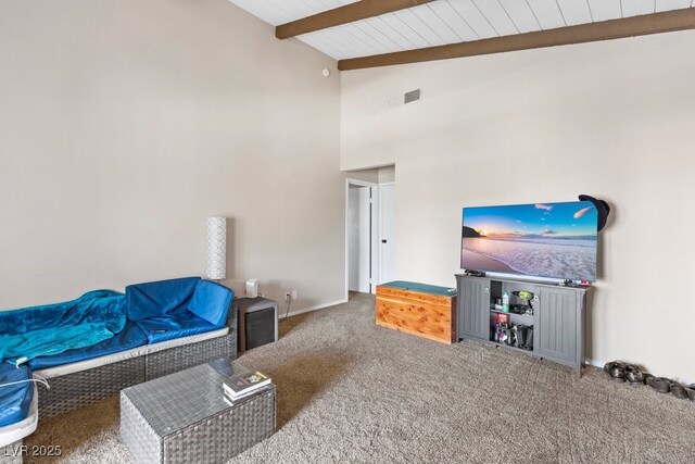 2643 Red Rock St Unit 201, Las Vegas, NV 89146 - carpeted living area featuring wooden ceiling with exposed beams, baseboards, and high vaulted ceiling