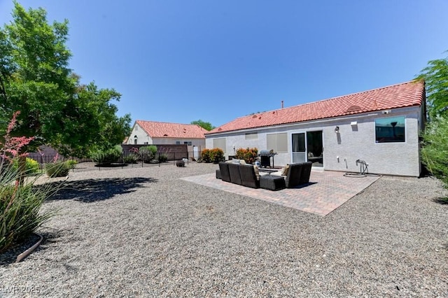 3823 Aspen Creek Ave, North Las Vegas, NV 89031 - rear view of property featuring a tiled roof, a fenced backyard, a patio area, outdoor lounge area, and stucco siding