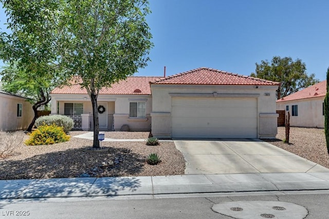 3823 Aspen Creek Ave, North Las Vegas, NV 89031 - mediterranean / spanish-style home with a tile roof, stucco siding, an attached garage, and concrete driveway