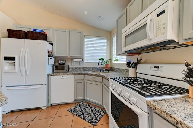 3823 Aspen Creek Ave, North Las Vegas, NV 89031 - kitchen with white appliances, a sink, lofted ceiling, light tile patterned flooring, and light stone counters
