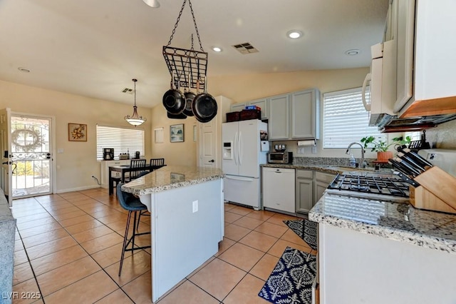 3823 Aspen Creek Ave, North Las Vegas, NV 89031 - kitchen with white appliances, a sink, plenty of natural light, a kitchen breakfast bar, and recessed lighting
