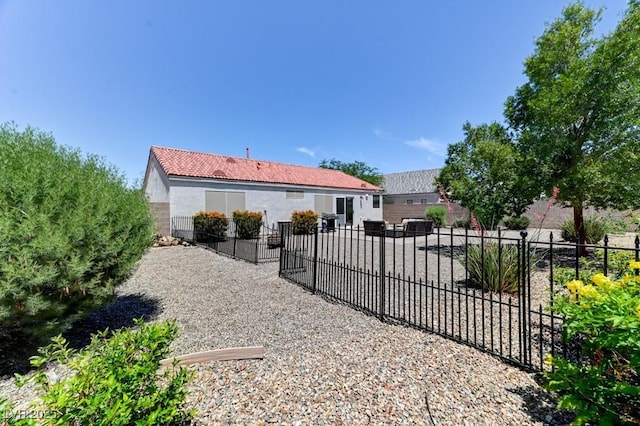 3823 Aspen Creek Ave, North Las Vegas, NV 89031 - back of house with stucco siding and a tiled roof