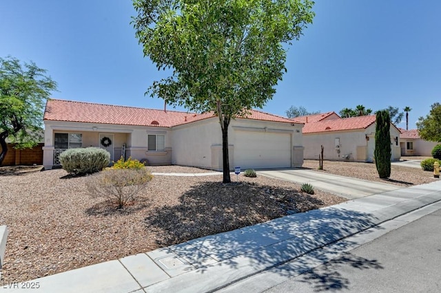 3823 Aspen Creek Ave, North Las Vegas, NV 89031 - view of front of home with a tile roof, stucco siding, an attached garage, and driveway