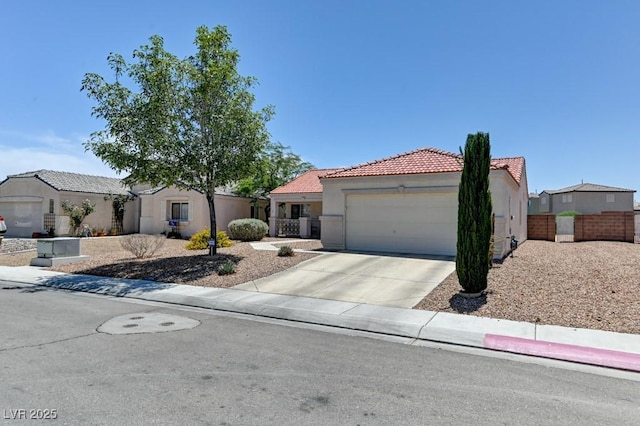 3823 Aspen Creek Ave, North Las Vegas, NV 89031 - mediterranean / spanish-style home featuring a tile roof, an attached garage, stucco siding, and concrete driveway