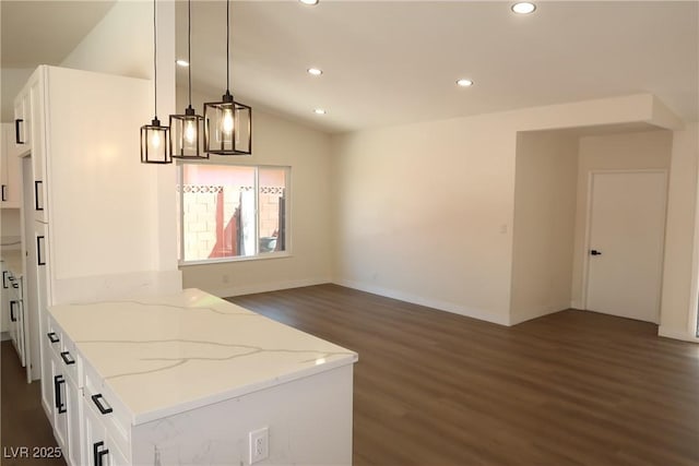 404 Vassar Ln, Las Vegas, NV 89107 - kitchen with dark wood finished floors, white cabinetry, recessed lighting, light stone countertops, and vaulted ceiling
