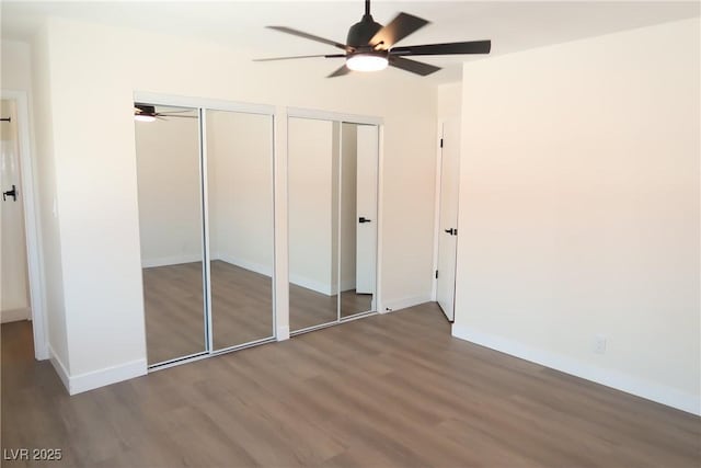 404 Vassar Ln, Las Vegas, NV 89107 - unfurnished bedroom with multiple closets, wood finished floors, and baseboards