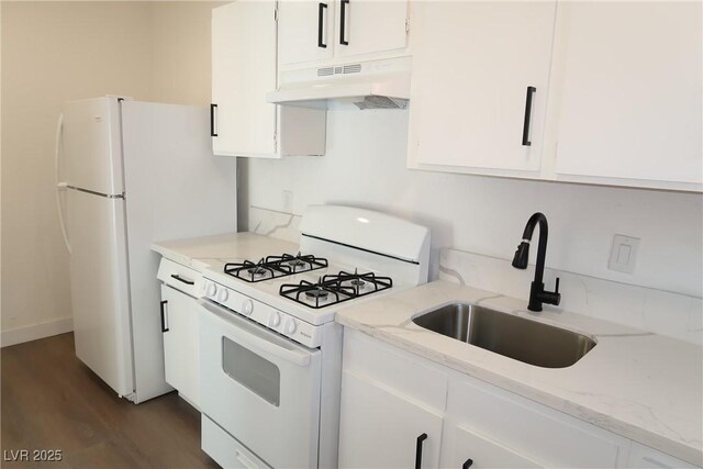 404 Vassar Ln, Las Vegas, NV 89107 - kitchen featuring white appliances, under cabinet range hood, a sink, dark wood-style floors, and white cabinetry