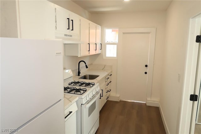 404 Vassar Ln, Las Vegas, NV 89107 - kitchen with white appliances, extractor fan, a sink, light countertops, and dark wood finished floors