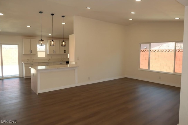 404 Vassar Ln, Las Vegas, NV 89107 - kitchen with dark wood-type flooring, white cabinets, recessed lighting, light countertops, and decorative light fixtures