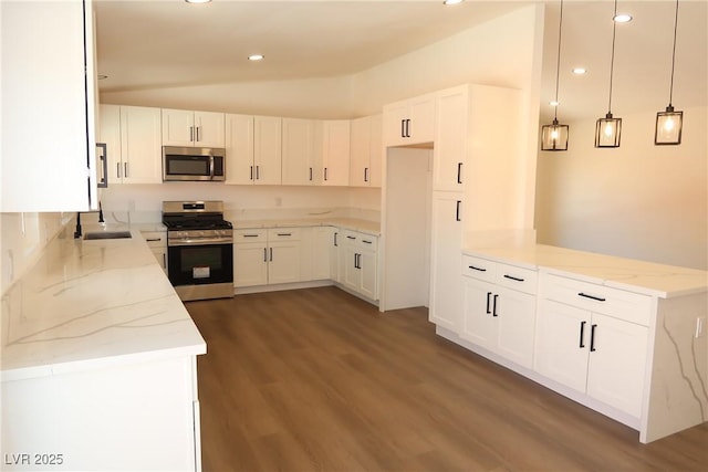 404 Vassar Ln, Las Vegas, NV 89107 - kitchen featuring stainless steel appliances, vaulted ceiling, light stone countertops, a sink, and wood finished floors