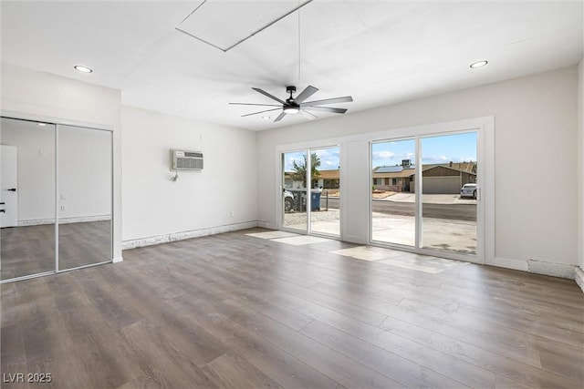 404 Vassar Ln, Las Vegas, NV 89107 - unfurnished bedroom with access to outside, wood finished floors, a wall unit AC, recessed lighting, and baseboards