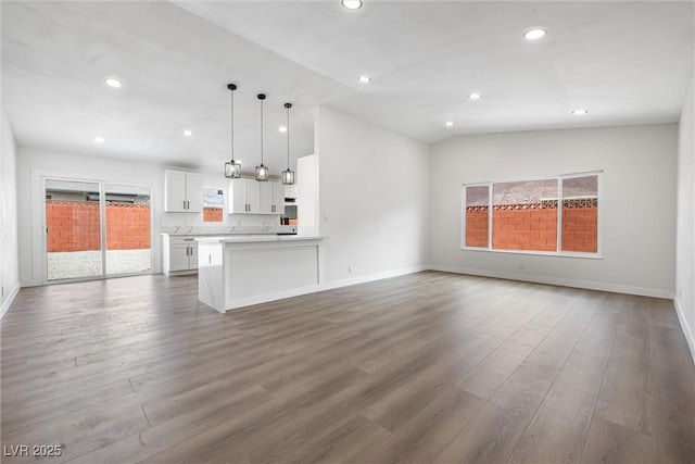 404 Vassar Ln, Las Vegas, NV 89107 - unfurnished living room with dark wood finished floors, vaulted ceiling, recessed lighting, and baseboards