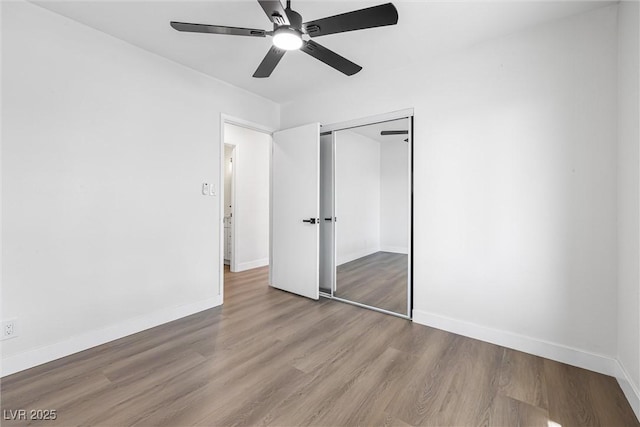404 Vassar Ln, Las Vegas, NV 89107 - unfurnished bedroom with wood finished floors, a closet, baseboards, and a ceiling fan