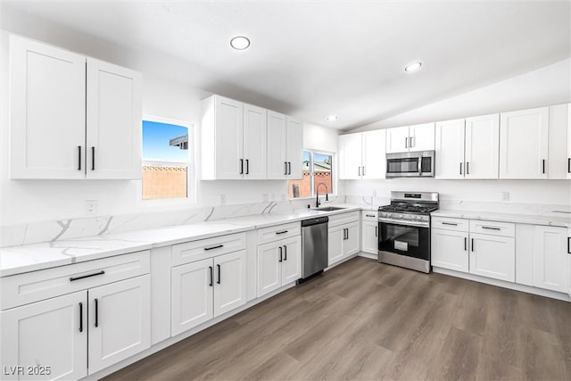 404 Vassar Ln, Las Vegas, NV 89107 - kitchen with appliances with stainless steel finishes, a sink, lofted ceiling, white cabinetry, and recessed lighting