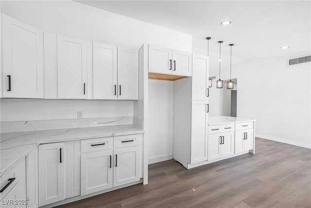 404 Vassar Ln, Las Vegas, NV 89107 - kitchen featuring baseboards, light stone counters, white cabinets, and recessed lighting