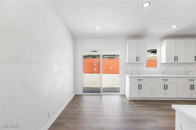 404 Vassar Ln, Las Vegas, NV 89107 - kitchen featuring plenty of natural light, white cabinetry, dark wood finished floors, recessed lighting, and a textured wall