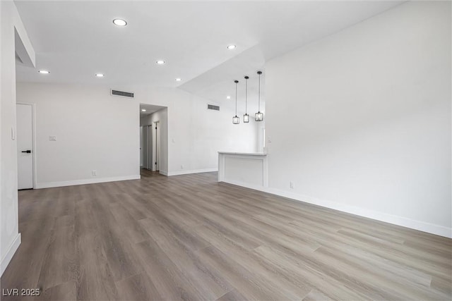 404 Vassar Ln, Las Vegas, NV 89107 - unfurnished living room with recessed lighting, wood finished floors, baseboards, and lofted ceiling