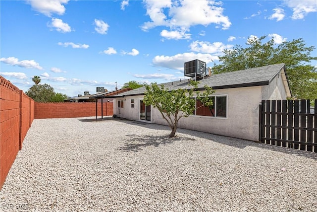 404 Vassar Ln, Las Vegas, NV 89107 - rear view of house featuring cooling unit, a fenced backyard, stucco siding, and a patio area