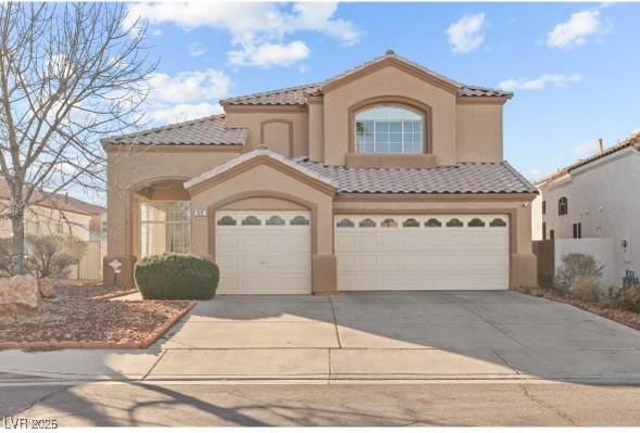 59 Desert Dawn Ln, Henderson, NV 89074 - mediterranean / spanish-style home featuring stucco siding, a tiled roof, driveway, and an attached garage