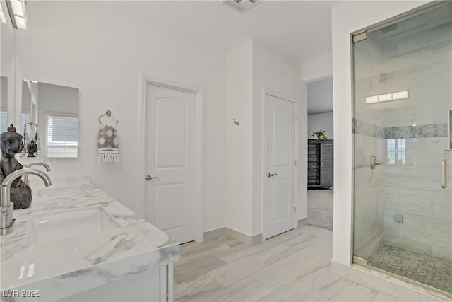 5742 Shadow Bend Dr, Las Vegas, NV 89135 - full bathroom featuring a shower stall, double vanity, baseboards, and marble finish floors
